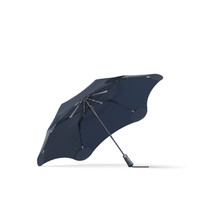 A navy BLUNT Metro Umbrella with a unique design and a metallic frame. It features a logo on the handle.