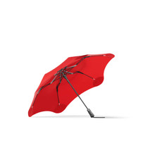 A red BLUNT Metro Umbrella with a sleek design and a black handle, featuring a logo on the fabric.