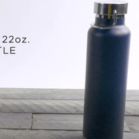 A drink bottle in navy blue with a silver lid and a metal handle, featuring a logo on the front.