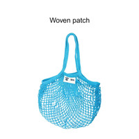 A blue mesh grocery bag with two handles and a woven patch. It has an open design for easy storage.