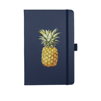 A navy journal with a pineapple illustration on the cover. It features an elastic band closure and has branding.