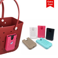 A red EVA tote bag with holes, featuring a matching plastic insert. Available in various colours: pink, white, beige, turquoise, and black.