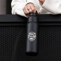 A drink bottle in matte black with a logo, featuring a twist lid and a durable design.
