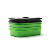 Green and black stackable food storage container for kitchen organization.