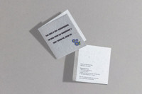A small seed paper greeting card in grey with a floral design and text about planting. It has a logo on one side.