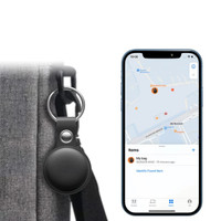 A black tracking tag attached to a bag, with a smartphone displaying a map and item location.