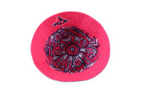 A reversible bucket hat featuring a vibrant pink exterior with a patterned interior. It includes a logo.