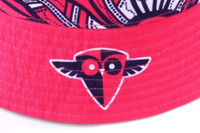 A reversible bucket hat in vibrant pink with a patterned brim and a logo on the side.