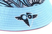 A blue and patterned reversible bucket hat featuring a logo on the side. The inside has a contrasting colour.
