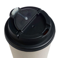 A reusable coffee cup in a light color with a black comfort lid and a small opening for sipping.