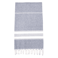 A 100% cotton Turkish towel in grey and white with tasselled edges, suitable for beach use.