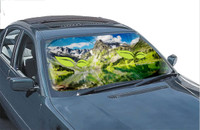 A sunshade featuring a scenic mountain and lake design, predominantly green and blue, with branding included.