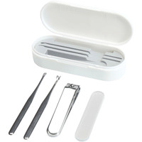 A white manicure set containing a nail clipper, tweezers, and other tools, all housed in a matching case.
