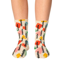 Colourful socks featuring various shapes and a logo pattern in hues of yellow, green, red, and orange.