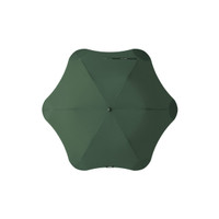 A green BLUNT Metro umbrella with a unique octagonal shape and a central button for opening and closing.