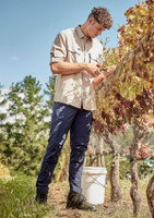 Men’s lightweight outdoor pants in navy blue, featured during outdoor activities, with a logo present on the garment.
