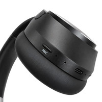 A pair of black wireless headphones featuring buttons for noise cancellation and USB-C charging.
