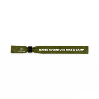 A green wristband with a logo and text detailing an adventure hiking and camping theme.