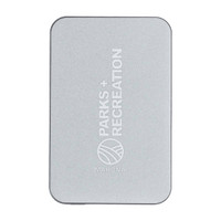 A silver power bank with a minimalist design and a logo. It features rounded corners and a sleek finish.