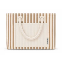 Folded beige and white striped Hampton tote bag featuring dual carry handles, a large front pocket, and a compact design for easy storage.
