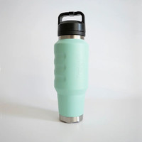 Side view of a mint green insulated 1L water bottle showcasing ergonomic finger-grip contours, a stainless steel base, and a carry-handle lid.