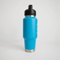 Front view of a bright blue insulated 1L water bottle with an ergonomic grip design, stainless steel base accents, and an integrated carry-handle lid.