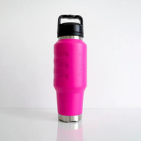 Angled front view of a vibrant pink insulated 1L water bottle showcasing textured finger-grip contours, a durable stainless steel base, and a secure carry-handle lid.
