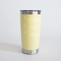 Front view of a pale yellow fridgy® 600ml insulated tumbler featuring ergonomic grip contours, embossed branding, a stainless steel base, and a clear push-on lid.