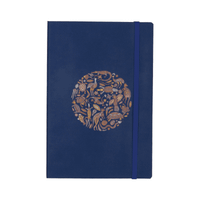 A navy blue soft bound journal featuring a decorative circle design and an elastic closure.