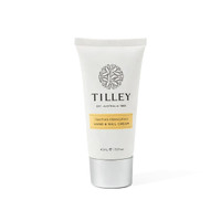 A hand and nail cream tube in white and silver, featuring a floral logo and a yellow label.
