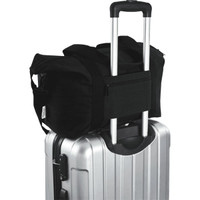 A black recycled canvas sports bag sits atop a silver suitcase, featuring a logo and sturdy handles.