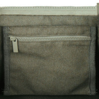 A zipped pocket inside a grey tote bag, featuring a textured fabric design. The bag has a simple, modern look.