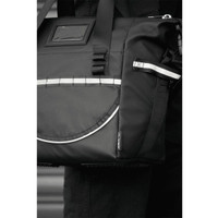 A black cooler bag features reflective detailing and multiple pockets, designed for carrying items securely. It has a logo.