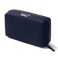 A navy blue tech kit with a textured surface and a zip closure. It features a logo on the front.