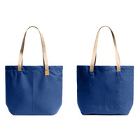 A blue tote bag with beige straps, featuring a simple design and a logo on the front.