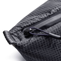 A close-up of a black, textured cooler bag featuring a zipper and a handle. It has a subtle diamond pattern.