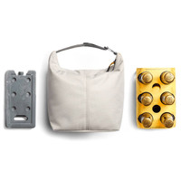 A cooler bag in light grey, accompanied by an ice pack and a four-pack of bottled drinks, showcasing its functionality.