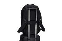 A black backpack with straps, designed to fit securely on a wheeled suitcase, featuring a logo.