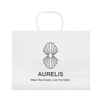 A large white paper bag with a decorative logo design and handles. Features minimalistic branding and text.
