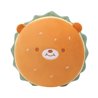 A round, plush toy shaped like a hamburger, featuring a smiling bear face and orange and green colours.