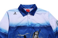 A blue and white fishing polo shirt with a graphic of a fish and a fishing scene, featuring a collar and branding.