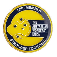 A circular lapel pin in yellow and black featuring a map of Australia and text, including "Life Member" and "Stronger Together".