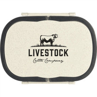 A cream lunch box with a black lid and an embossed logo featuring a cow and text branding.