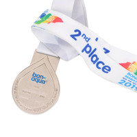 A silver medal with a drop-shaped design, attached to a white ribbon featuring colourful branding.