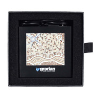 A black 3-in-1 charger with a patterned design, placed in a black cushioned box. Features a logo on the front.