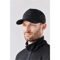 A black cap worn by a man, featuring a curved brim and a fitted design, with a logo on the front.