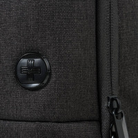 A black backpack featuring a textured surface and a round logo. The zipper detail is also visible.