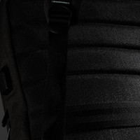 A black backpack featuring textured fabric and adjustable straps, with a logo on the side.