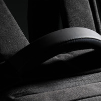 A black backpack featuring padded straps and textured fabric, with a small logo visible.