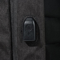 A close-up of a feature on a black backpack, showcasing a zipper pull and textured fabric.
